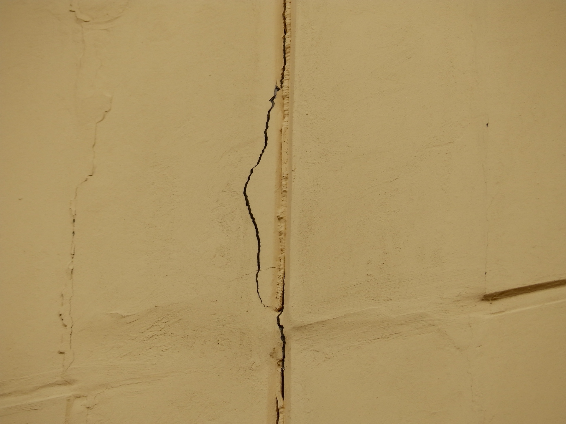 Опасные трещины. Усадочные трещины в штукатурном слое. Трещина на штукатурке на стене. Трещины в перегородках. Сквозная трещина в стене.